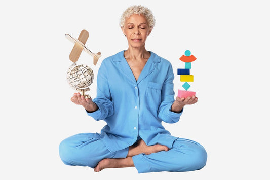 Elderly woman in blue pajamas meditating with toys and globe from flying tiger copenhagen in hands.