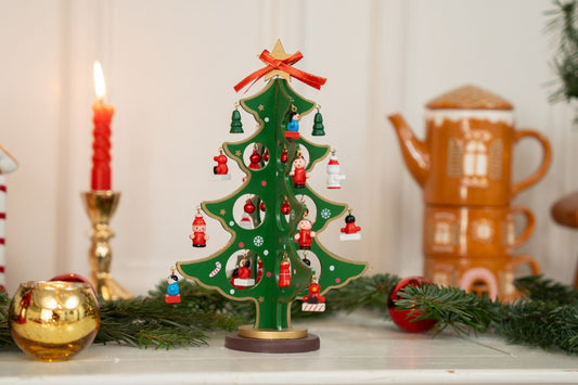 A decorative Christmas tree with ornaments, candles, and festive decor.