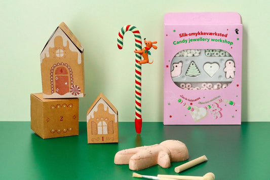 Colorful wooden toys including houses, a candy cane, and a pink box.