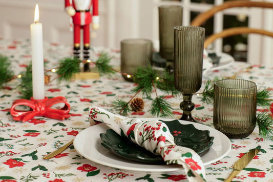 Table set for a festive meal with holiday decorations and candles.