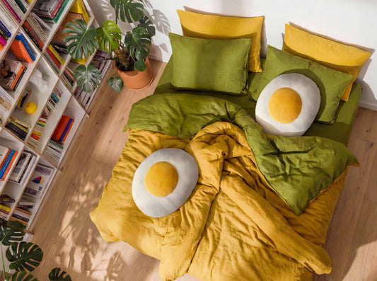 Colorful bedding set with egg-shaped cushions and a bookshelf in the background.