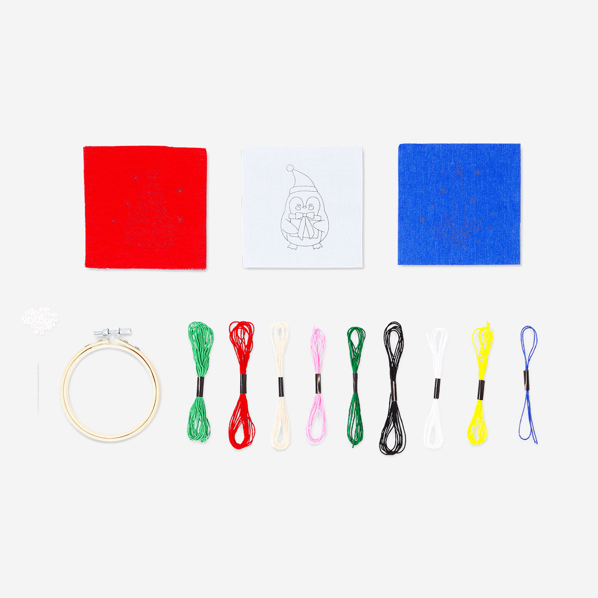 Christmas-themed embroidery kit by Flying Tiger Copenhagen featuring colorful threads, fabric, and embroidery patterns for holiday crafting.