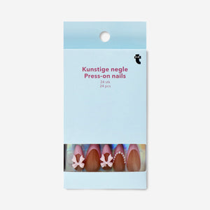Flying Tiger Copenhagen press-on nails with 3D pearls and bows, showcasing elegant, decorative nail art and personal care style.