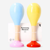 Pair of wooden maracas toy from Flying Tiger Copenhagen, showing colorful handles and textured surface for kids' musical play.