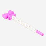 Pink ballpoint pen with a bow and pearl accents, designed for office use, by Flying Tiger Copenhagen.