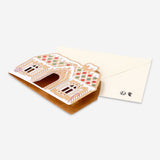 Office Christmas card featuring a festive gingerbread house design by Flying Tiger Copenhagen.