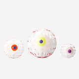 Three honeycomb paper eyes decorations for hanging, party decor by Flying Tiger Copenhagen, featuring colorful, textured eye shapes.