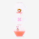Decorative hourglass gadget with candy monster icons, featuring clear glass and colorful playful design from Flying Tiger Copenhagen.