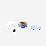 Three stackable personal care jars in clear plastic with white lids, branded by Flying Tiger Copenhagen.