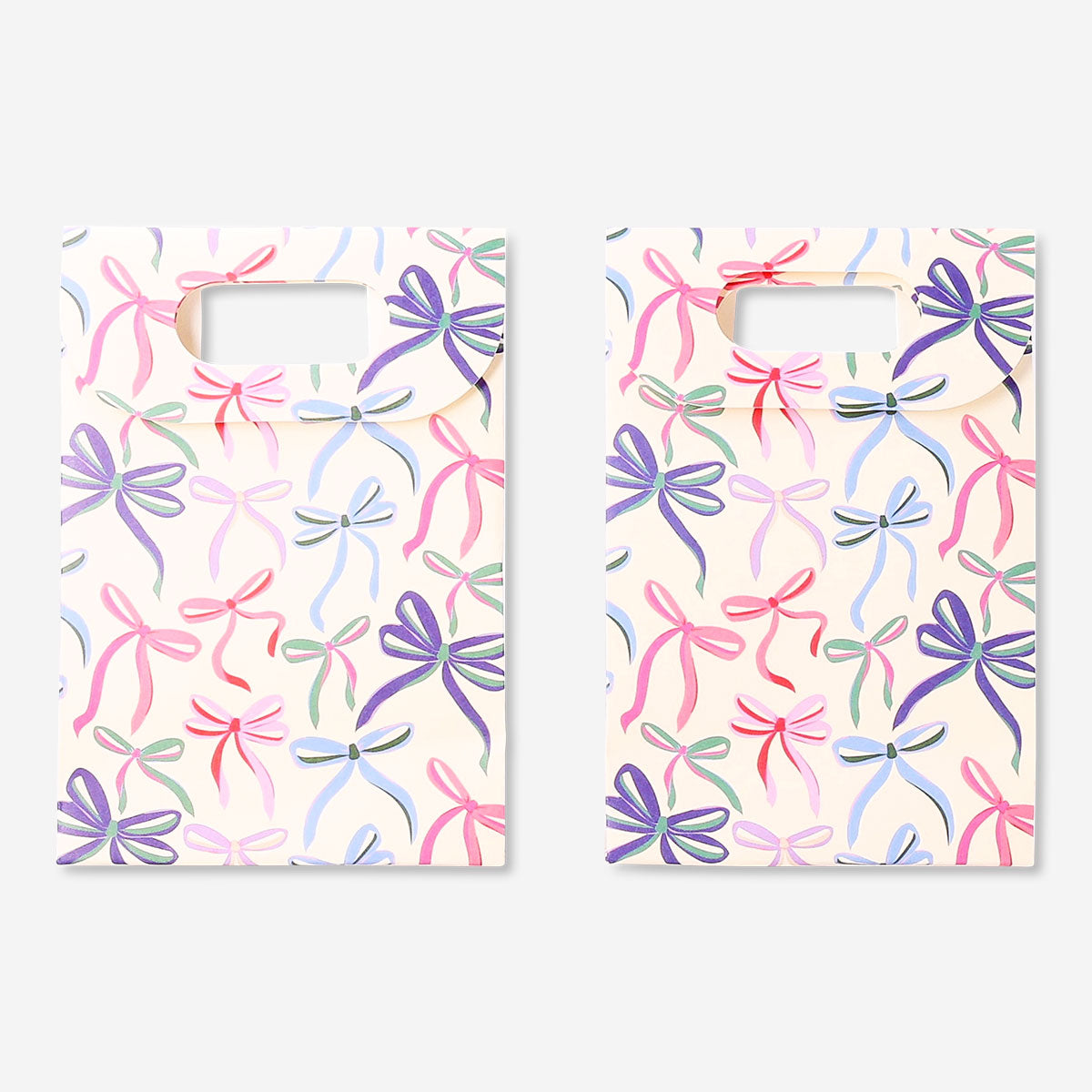 Two office gift bags with colorful bows from Flying Tiger Copenhagen, featuring festive paper design and sturdy handles.