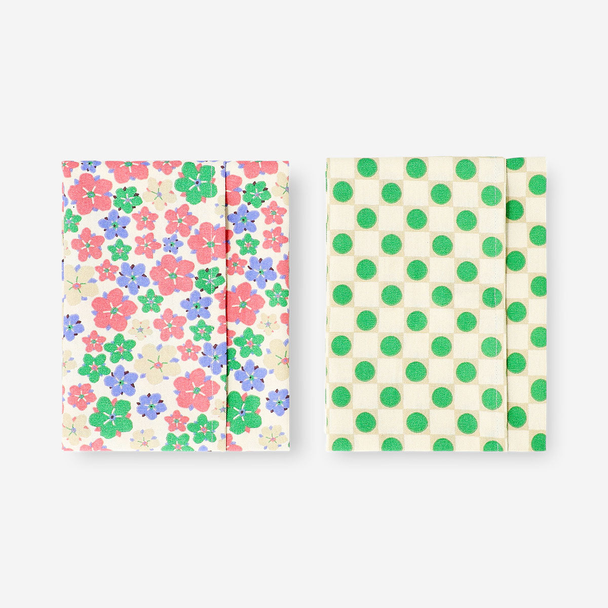 Set of two Flying Tiger Copenhagen kitchen tea towels with colorful dots and floral patterns, perfect for kitchen decor.