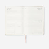 A5 fabric cover daily diary 2027 by Flying Tiger Copenhagen, open to pages with dates and writing space inside.