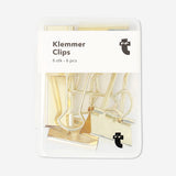 Set of six Flying Tiger Copenhagen office Bulldog clips for organizing papers and documents.