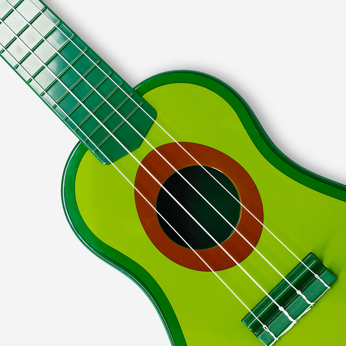 Flying Tiger Copenhagen avocado-shaped ukulele gadget with a green body and four strings, perfect for musical fun and novelty.