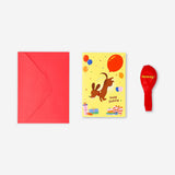 Flying Tiger Copenhagen birthday card featuring a cute sausage dog holding a balloon, perfect for celebrating special occasions.