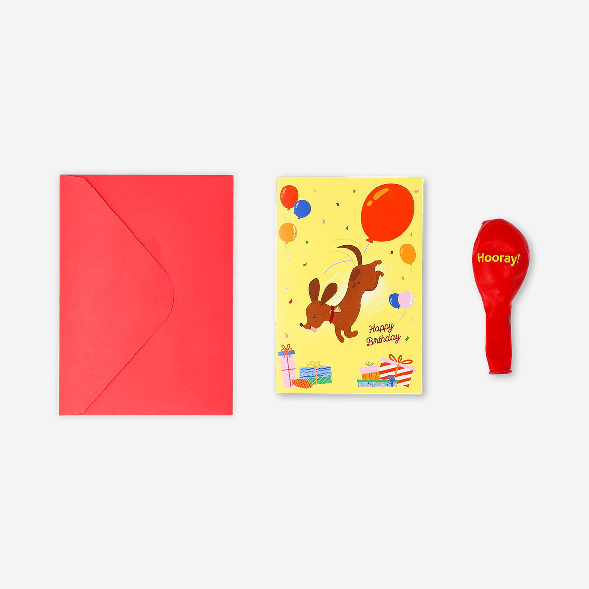 Flying Tiger Copenhagen birthday card featuring a cute sausage dog holding a balloon, perfect for celebrating special occasions.