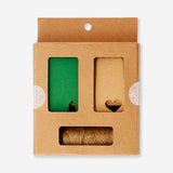 Green gift decoration set for office use by Flying Tiger Copenhagen, featuring colorful paper banners and decorative accents.