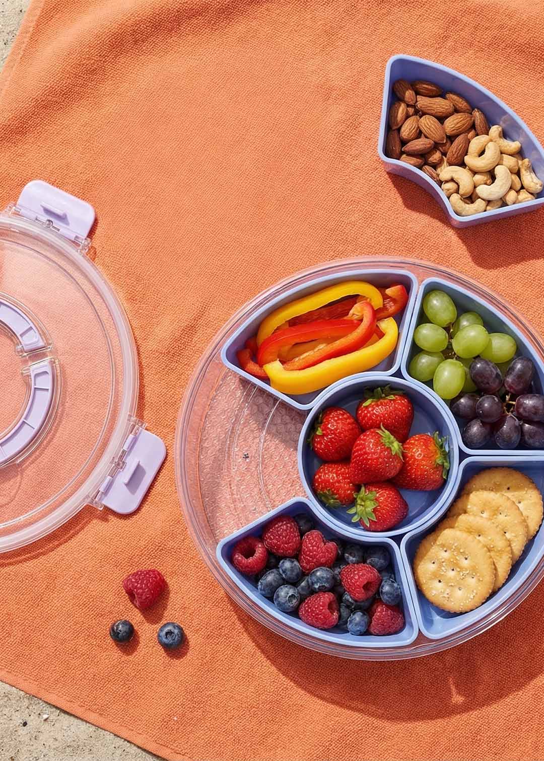 Blue rotating snack box with lid, kitchen storage container by Flying Tiger Copenhagen, designed for organizing snacks.