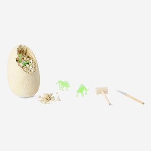 Glow-in-the-dark dinosaur excavation toy kit from Flying Tiger Copenhagen, includes tools and dinosaur figures for kids' play.