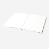 A5 green floral bullet planner from Flying Tiger Copenhagen with a vibrant floral cover and organized interior pages.