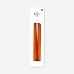 Two autumn-colored dinner candles in warm tones, designed for home decor by Flying Tiger Copenhagen.
