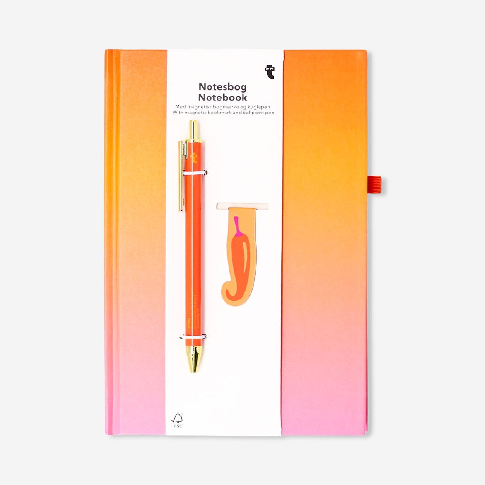 Gradient office notebook with magnetic bookmark and pen by Flying Tiger Copenhagen, open to show colorful pages and accessories.
