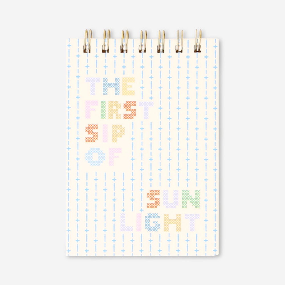 Spiral bound Office notepad by Flying Tiger Copenhagen with lined pages for note-taking and organization.