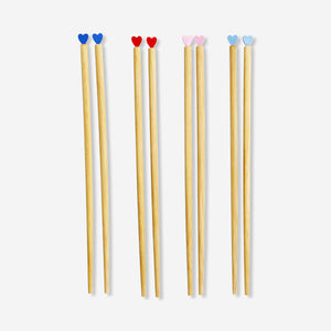 Set of four wooden chopsticks with heart-shaped toppers, ideal for kitchen use, by Flying Tiger Copenhagen.