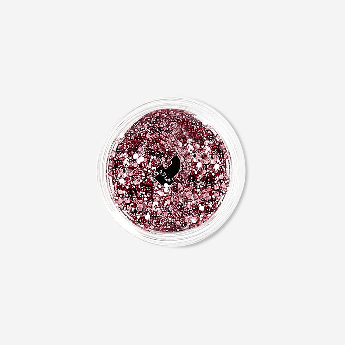 Pink glitter eyeshadow flakes from Flying Tiger Copenhagen, close-up of shimmering, sparkling cosmetic product for eye makeup.
