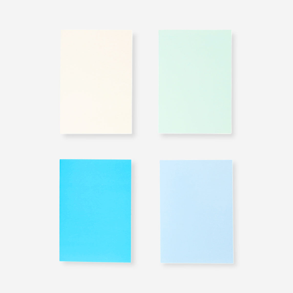 Four Flying Tiger Copenhagen A5 solid color office notebooks with smooth covers and elastic closures.