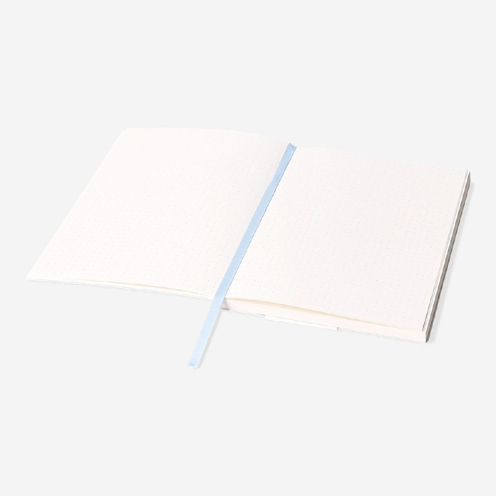 A5 floral bullet planner from Flying Tiger Copenhagen with colorful floral cover and open pages for planning and organization.