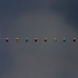 Multi-colored string lights with festive baubles from Flying Tiger Copenhagen, ideal for home holiday decoration.