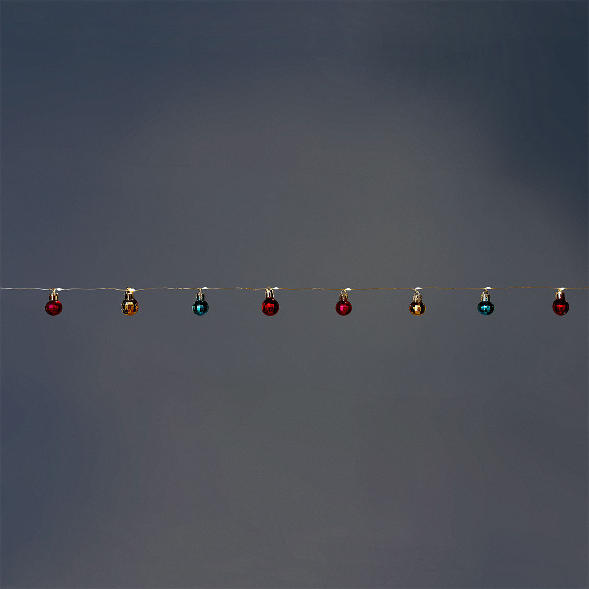 Multi-colored string lights with festive baubles from Flying Tiger Copenhagen, ideal for home holiday decoration.