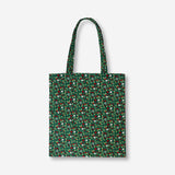 Green textile tote bag with holly leaf print from Flying Tiger Copenhagen, featuring sturdy handles and festive holiday design.