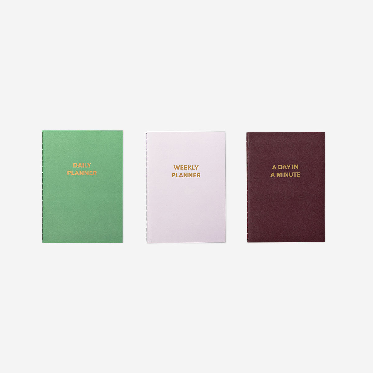 A set of three Flying Tiger Copenhagen A6 office planners in English with colorful covers, compact for daily organization.