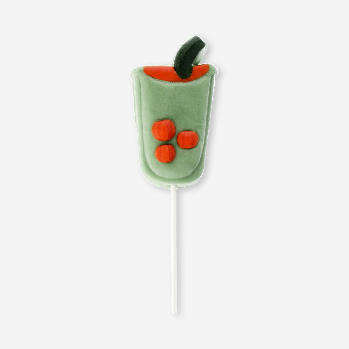 Iced Matcha gummy on a stick, a green tea-flavored candy from Flying Tiger Copenhagen, displayed on a wooden surface.
