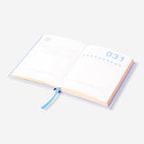 A6 memory journal from Flying Tiger Copenhagen with a hardcover, open pages, and colorful design for office or personal use.