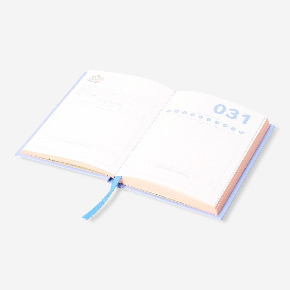 A6 memory journal from Flying Tiger Copenhagen with a hardcover, open pages, and colorful design for office or personal use.