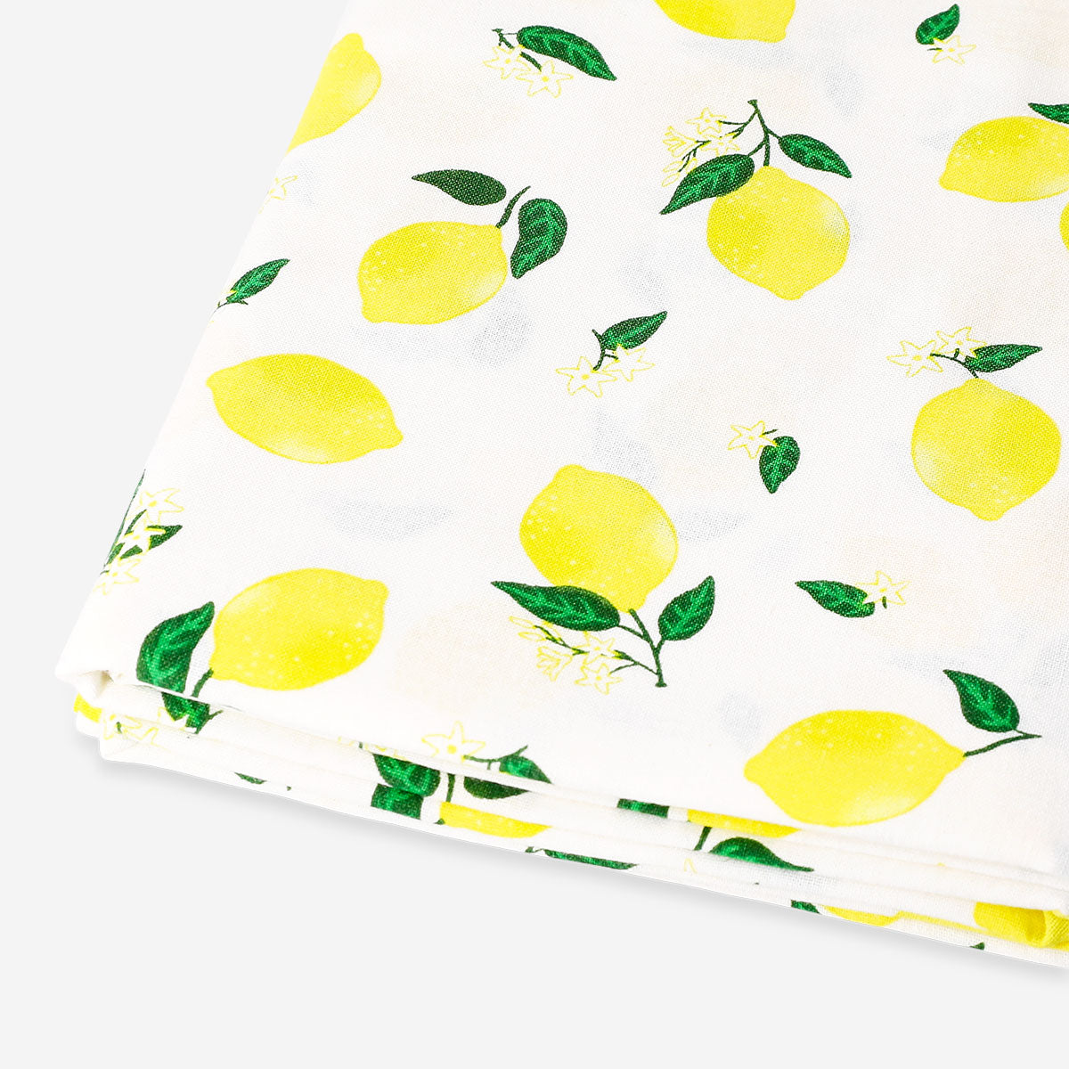 Lemon print tablecloth from Flying Tiger Copenhagen, 140x220 cm, featuring bright lemon illustrations on a white background.