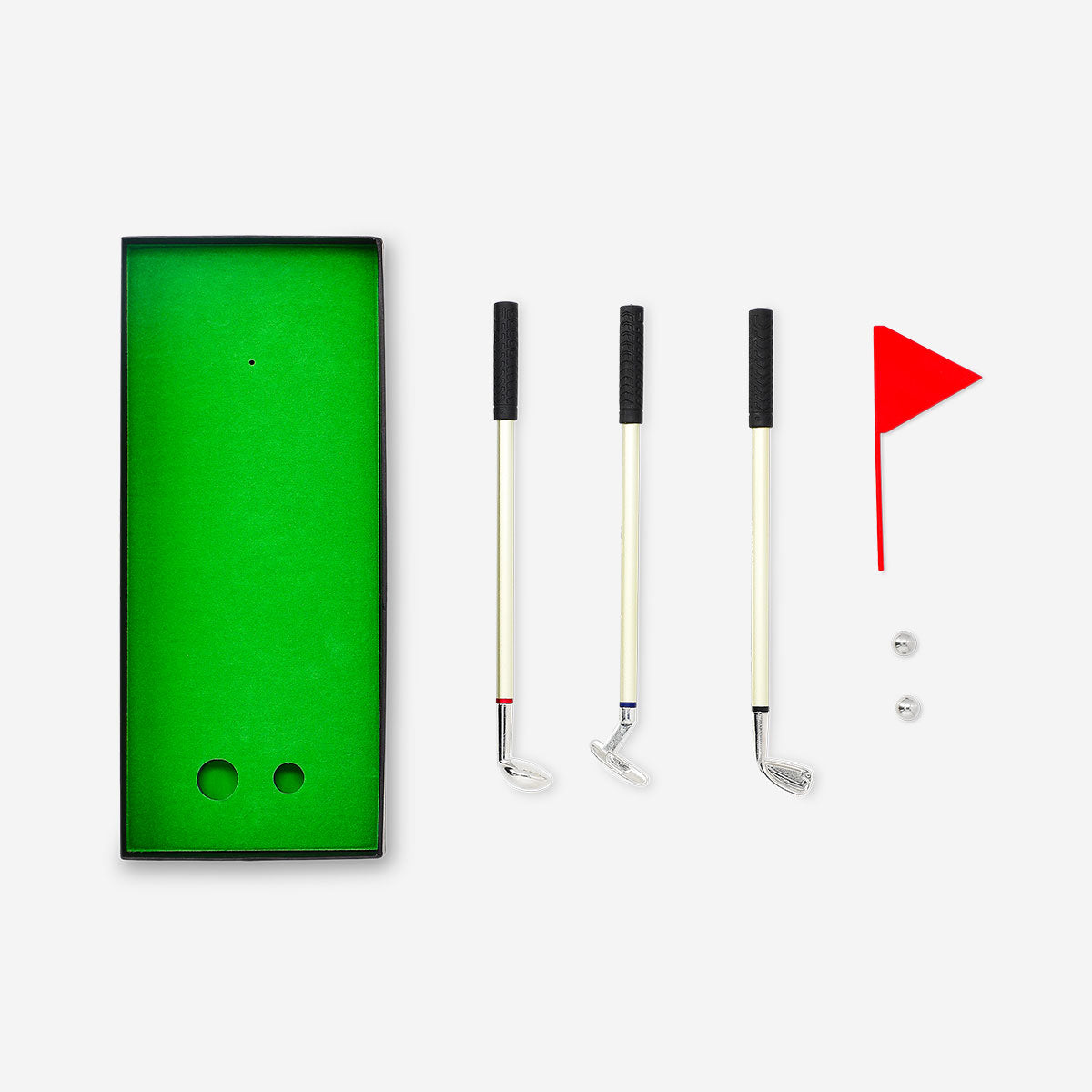Desktop golf game by Flying Tiger Copenhagen featuring miniature golf course with putters and balls on a wooden surface.
