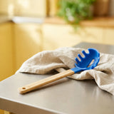Flying Tiger Copenhagen Designer Collection 28cm kitchen spoon, stainless steel with ergonomic handle, ideal for cooking and serving.
