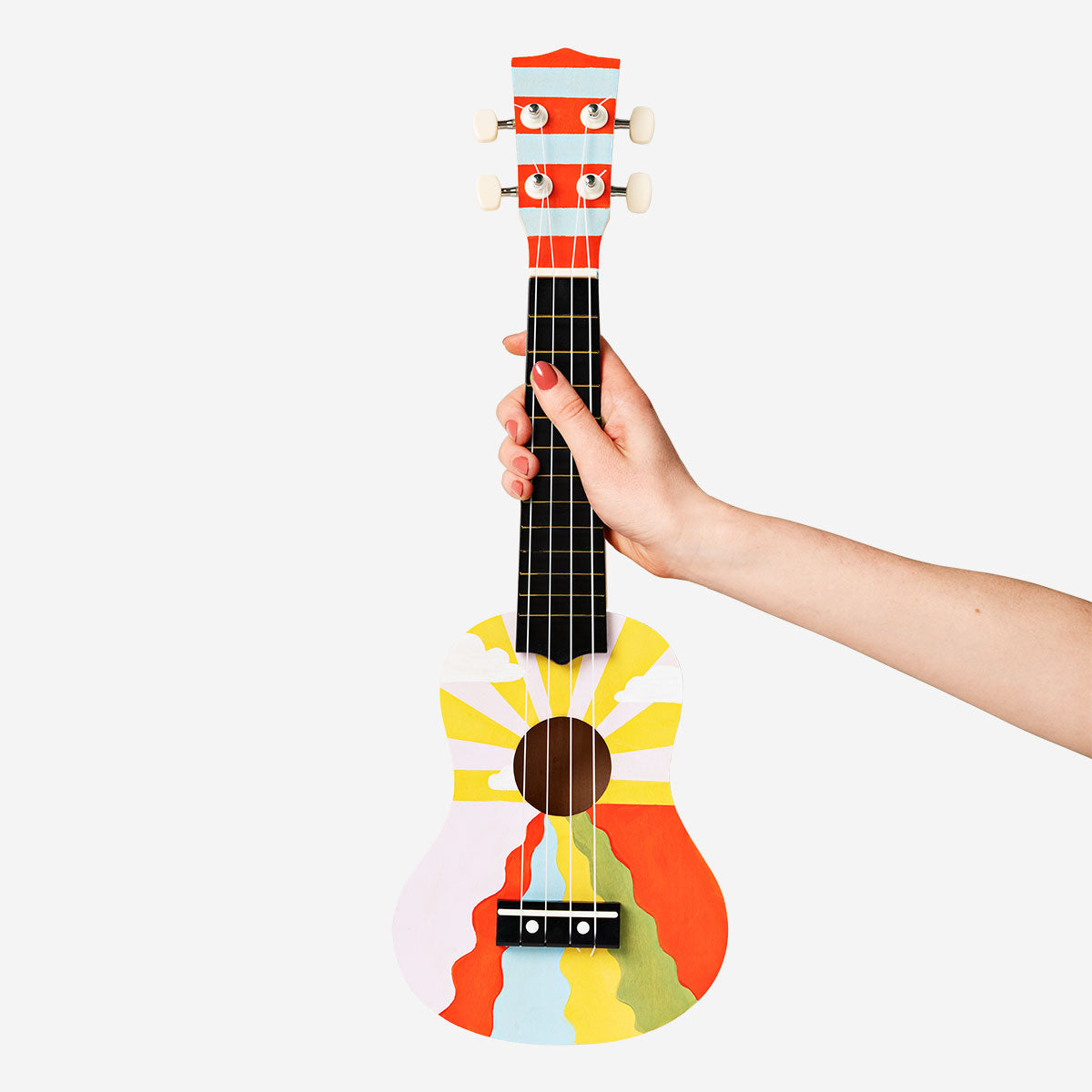 Colorful DIY ukulele kit from Flying Tiger Copenhagen with paint for customization, perfect for hobby music projects.