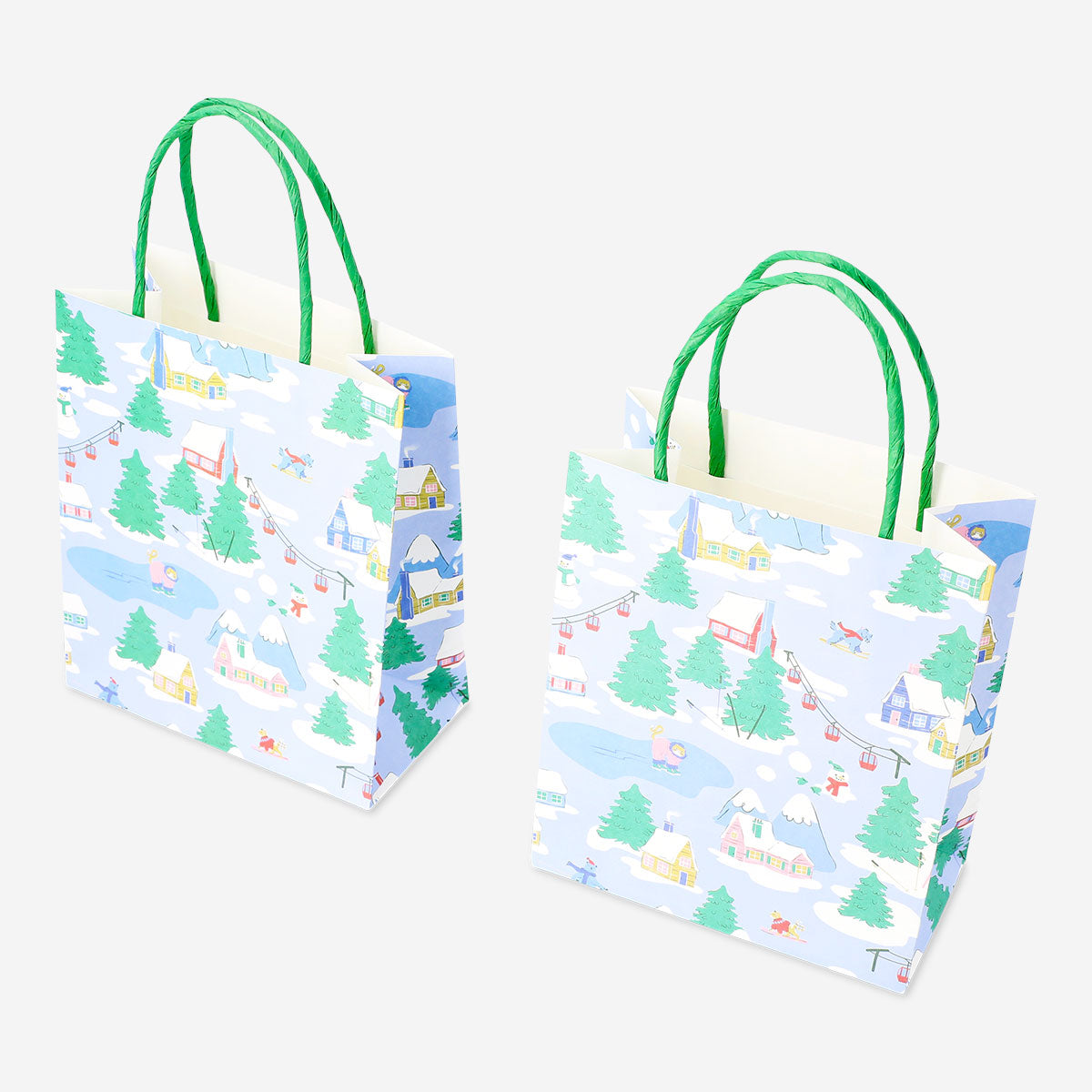 Two office gift bags featuring scenic lodge images, branded by Flying Tiger Copenhagen, with handles and colorful lodge scenery designs.