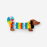 Wooden sausage dog alphabet puzzle toy from Flying Tiger Copenhagen featuring colorful alphabet pieces and a playful dog shape.
