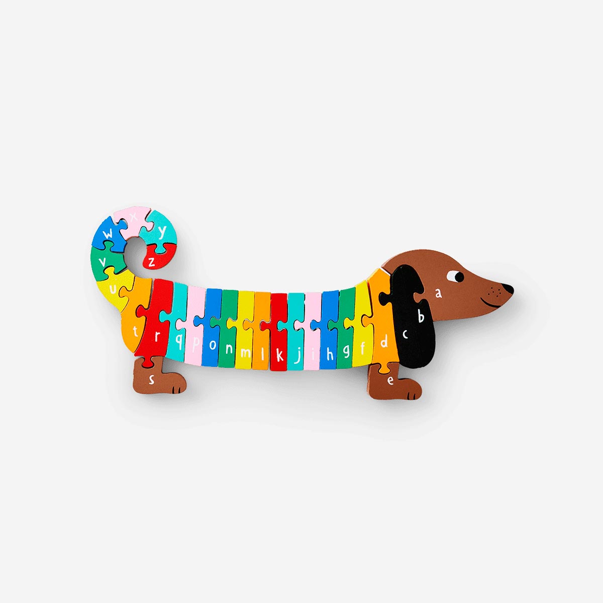 Wooden sausage dog alphabet puzzle toy from Flying Tiger Copenhagen featuring colorful alphabet pieces and a playful dog shape.