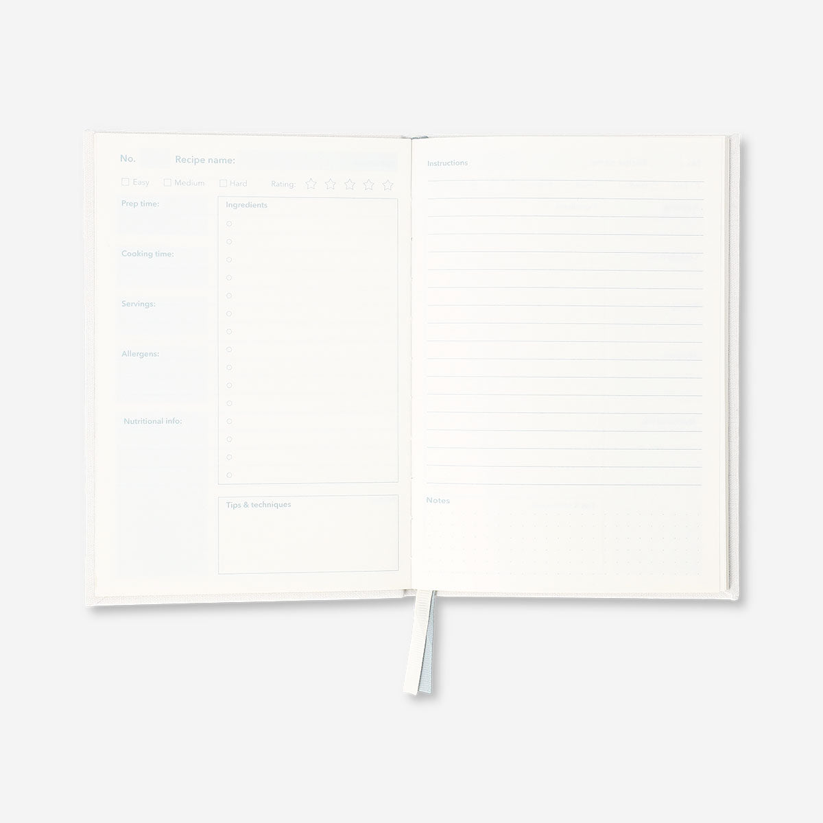 Flying Tiger Copenhagen office recipe book open to colorful pages with recipes and kitchen tips.