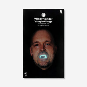 Glow in the dark vampire fangs from Flying Tiger Copenhagen, shown as a one-size set of spooky, plastic costume teeth for personal care.