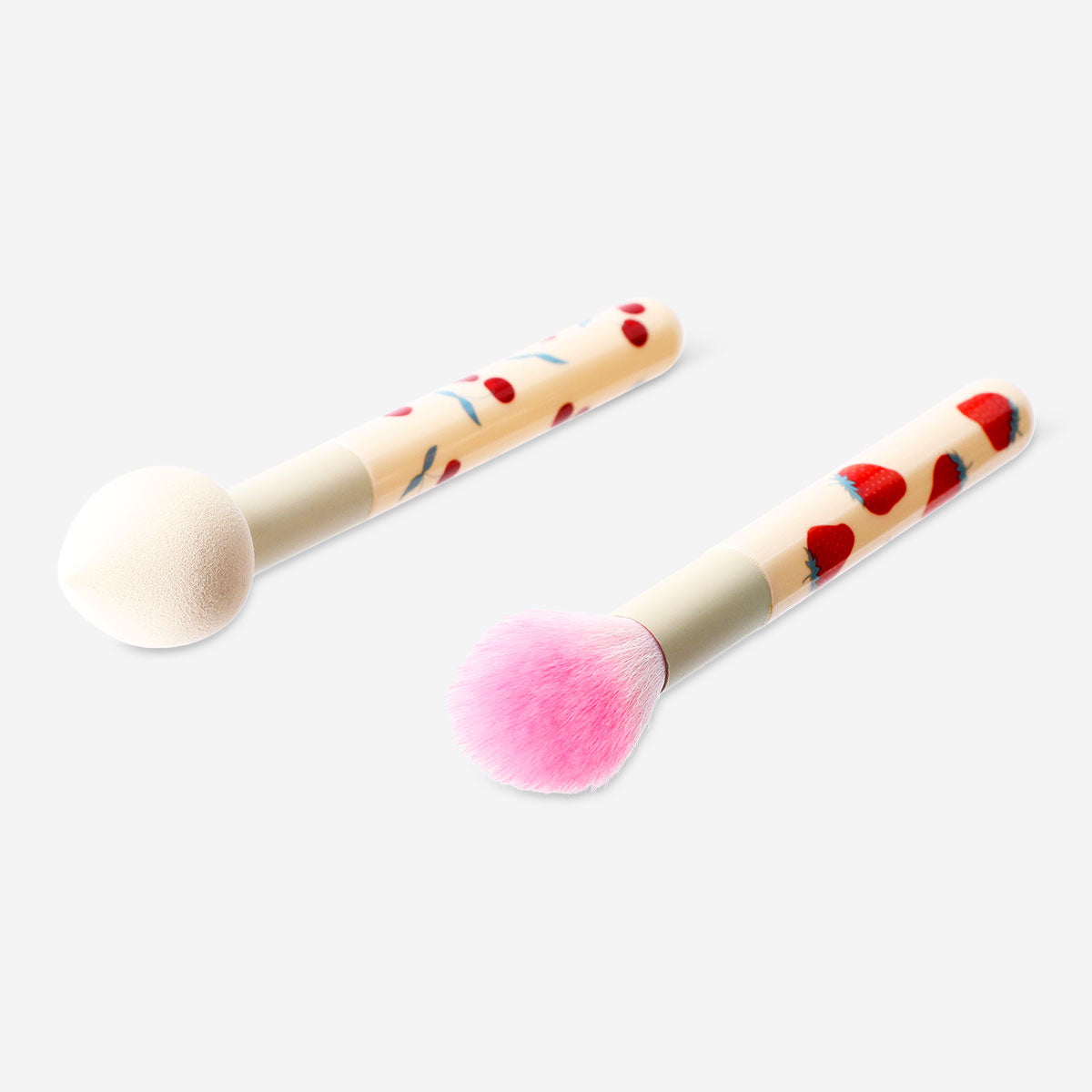 Set of two Flying Tiger Copenhagen makeup brushes with berry print handles, designed for personal care and makeup application.