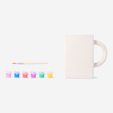 DIY ceramic book mug by Flying Tiger Copenhagen, shown with paint and brushes for hobby craft projects.