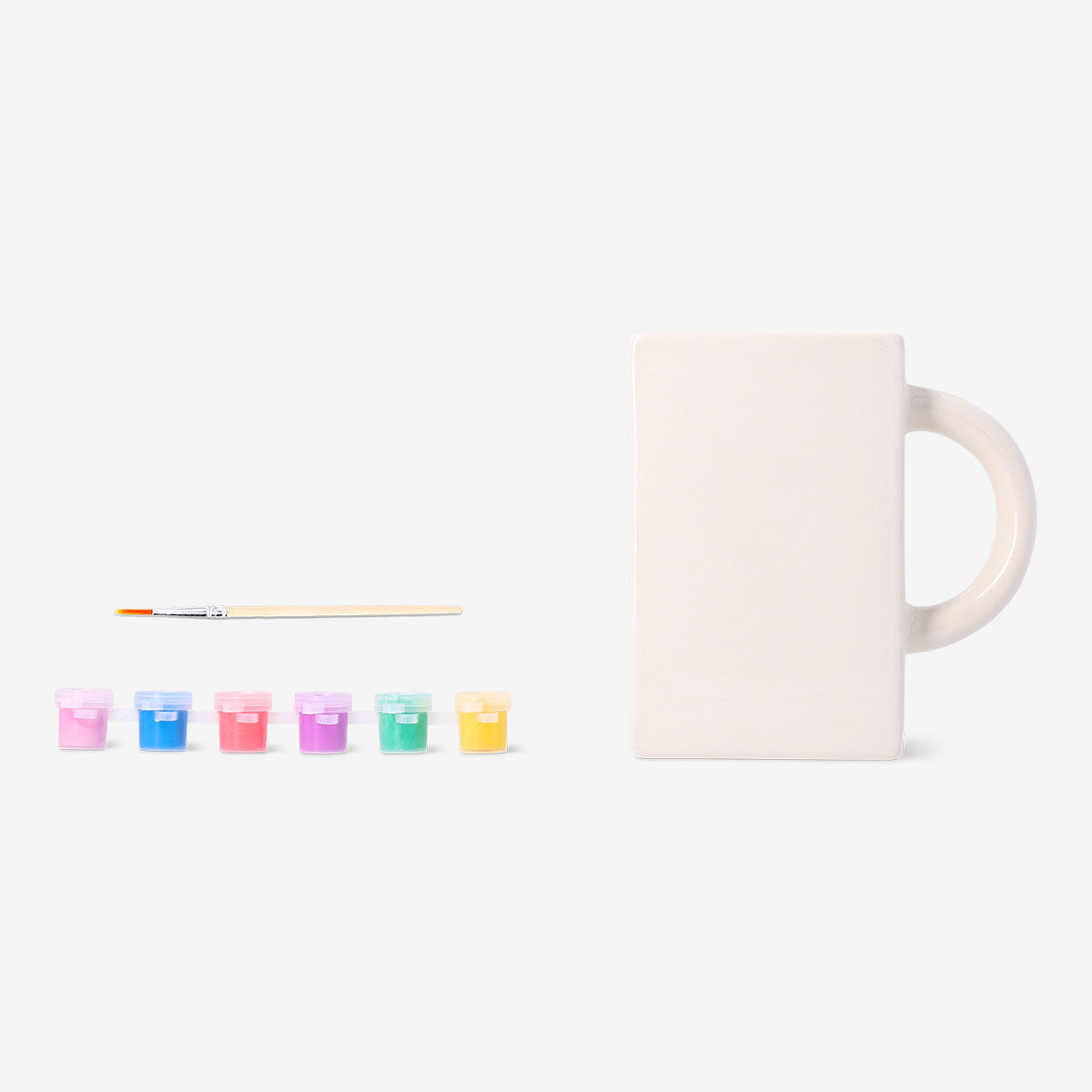 DIY ceramic book mug by Flying Tiger Copenhagen, shown with paint and brushes for hobby craft projects.